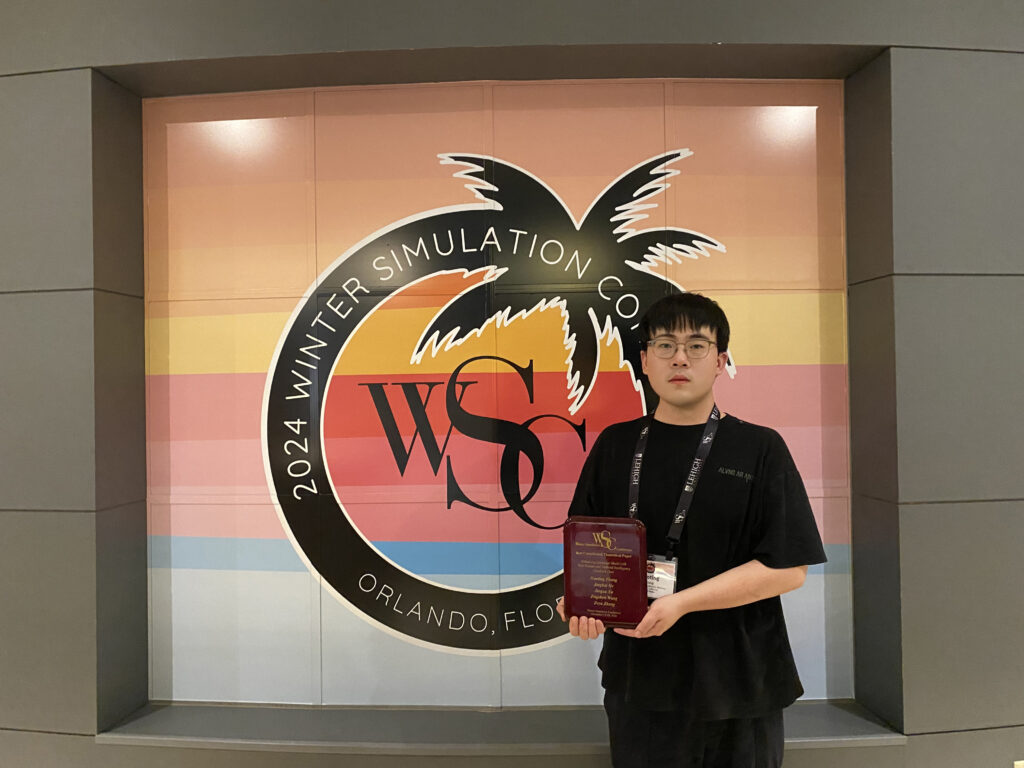 Photo of Haoting Zhang, the paper's first author, receiving the award plaque during the conference.